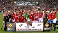 a group of manchester united players holding trophies
