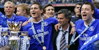 chelsea players celebrate with the trophy